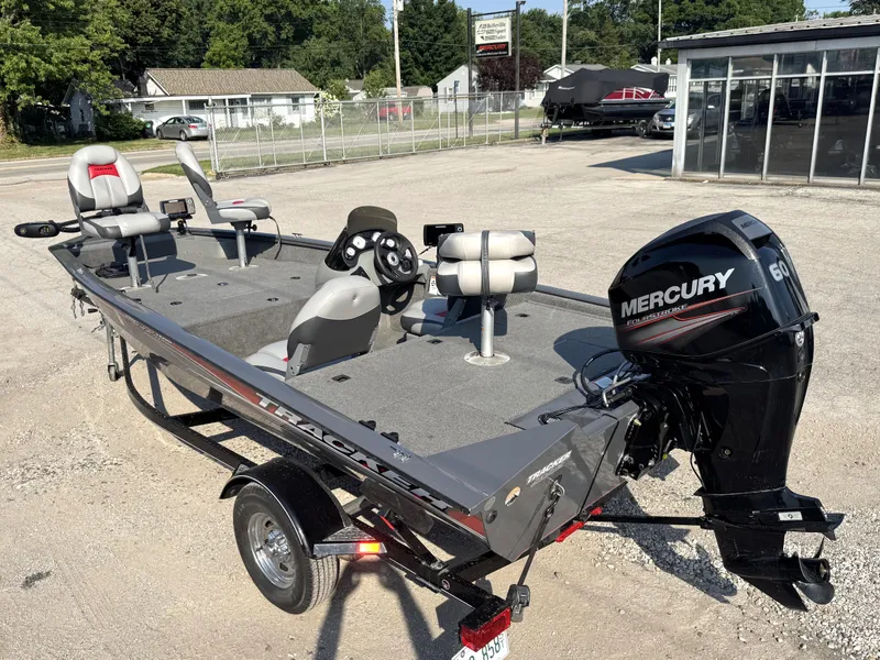 Slide: The Image of 2016 Tracker Pro Team 175 TF boat with Mercury 60 engine, parked outdoors. - 13