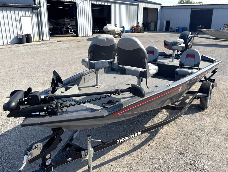 Slide: The Image of 2016 Tracker Pro Team 175 TF fishing boat with Minn Kota trolling motor in a boatyard. - 14