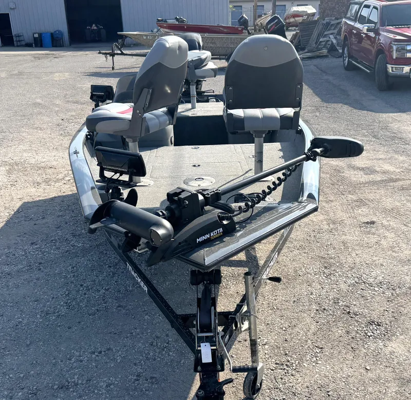 Slide: The Image of 2016 Tracker Pro Team 175 TF boat with Minn Kota trolling motor in a parking lot. - 15