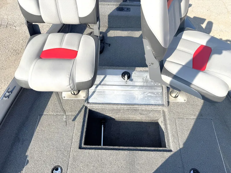Slide: The Image of 2016 Tracker Pro Team 175 TF boat interior with two seats and storage compartment. - 2