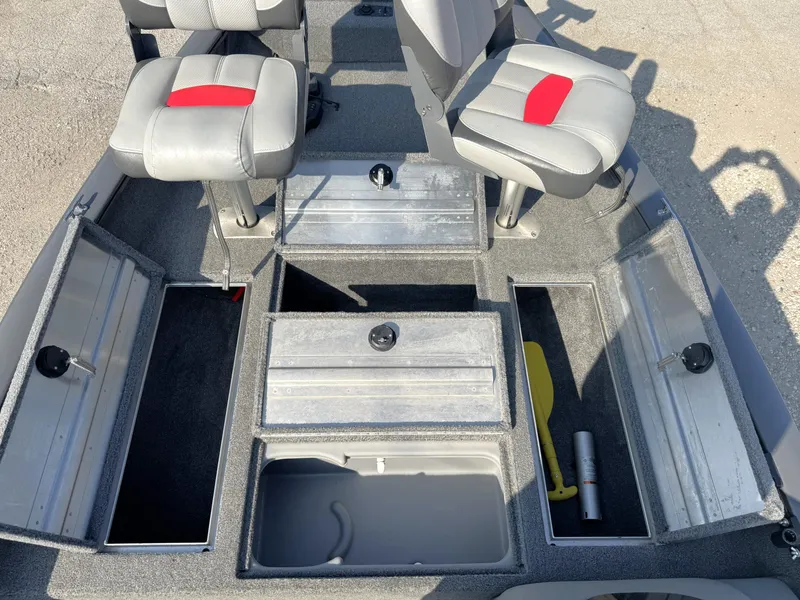 Slide: The Image of 2016 Tracker Pro Team 175 TF boat interior with storage compartments and seating. - 3
