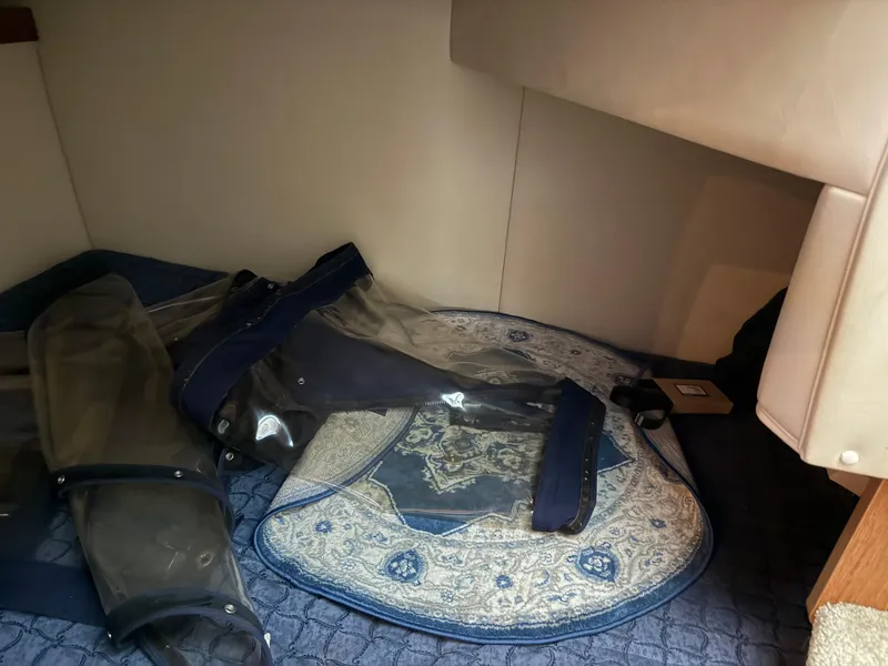 Slide: The Image of Interior cabin of 2004 Cruisers Yachts 280 Express with blue and beige decor. - 16