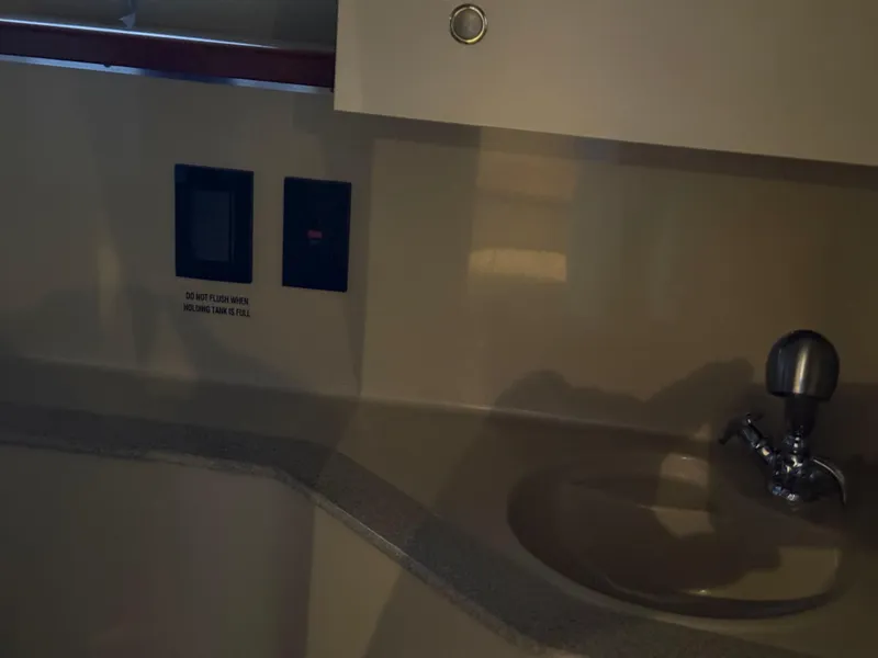 Slide: The Image of 2004 Cruisers Yachts 280 Express bathroom sink and control panel. - 18