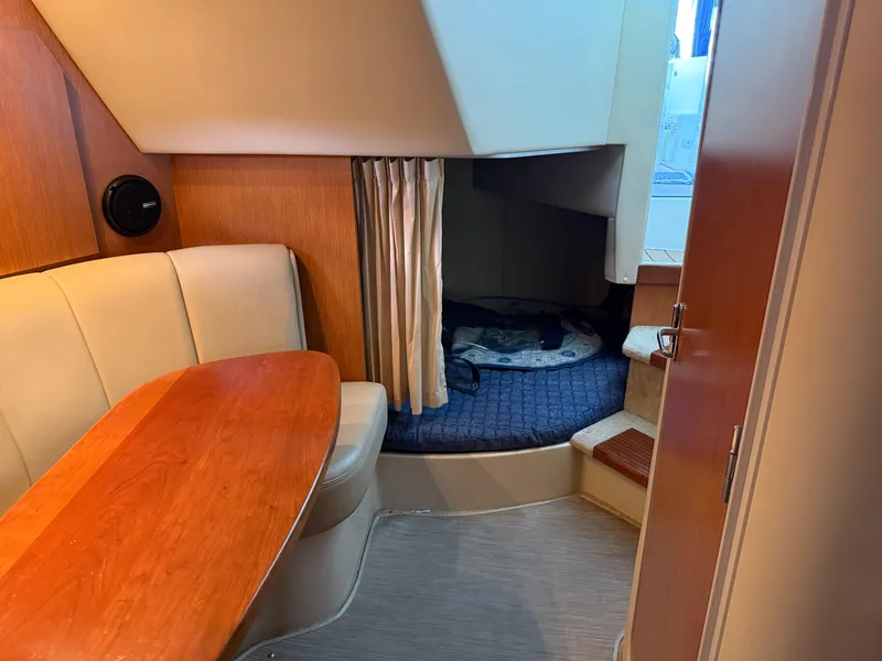 Slide: The Image of 2004 Cruisers Yachts 280 Express cabin interior with seating and sleeping area. - 20