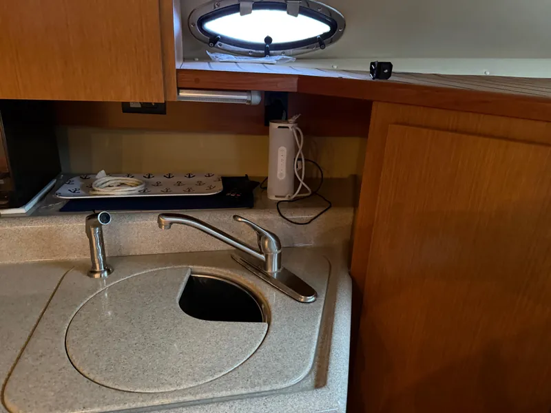 Slide: The Image of 2004 Cruisers Yachts 280 Express kitchen sink with faucet and countertop. - 22