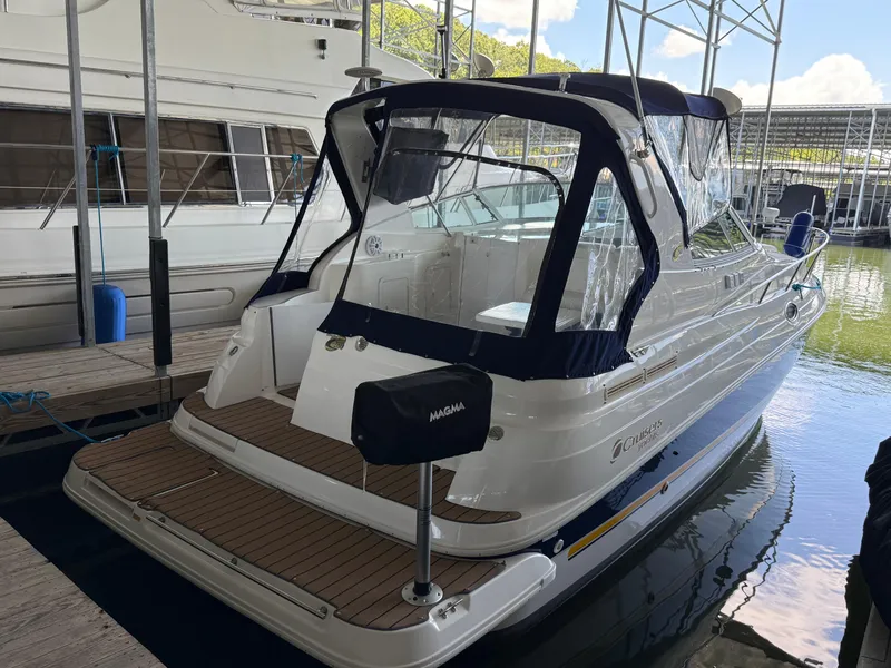 Slide: The Image of 2004 Cruisers Yachts 280 Express docked, featuring sleek design and covered cockpit. - 3