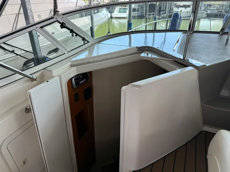 Slide: The Image of 2004 Cruisers Yachts 280 Express cabin entrance with open door, docked at marina. - 33