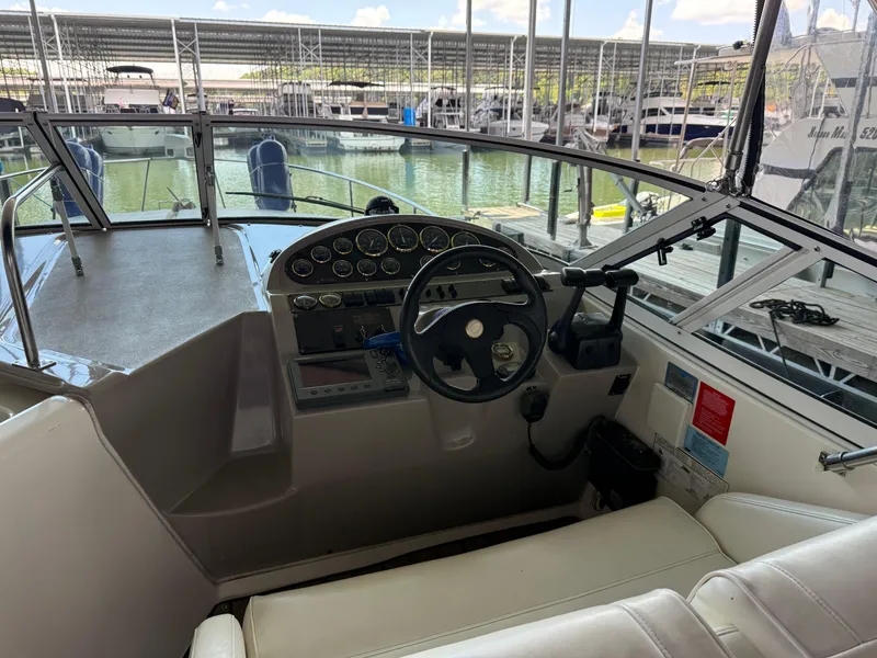 Slide: The Image of 2004 Cruisers Yachts 280 Express helm with steering wheel and instrument panel at marina. - 34