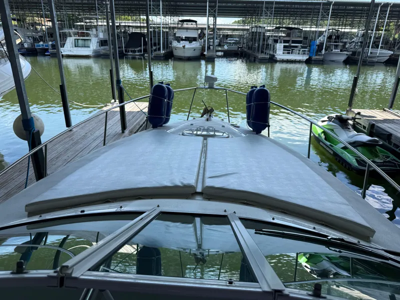 Slide: The Image of 2004 Cruisers Yachts 280 Express docked in a marina with other boats. - 7