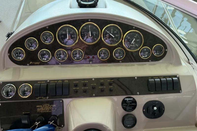 Slide: The Image of Dashboard of 2004 Cruisers Yachts 280 Express with gauges and controls. - 9