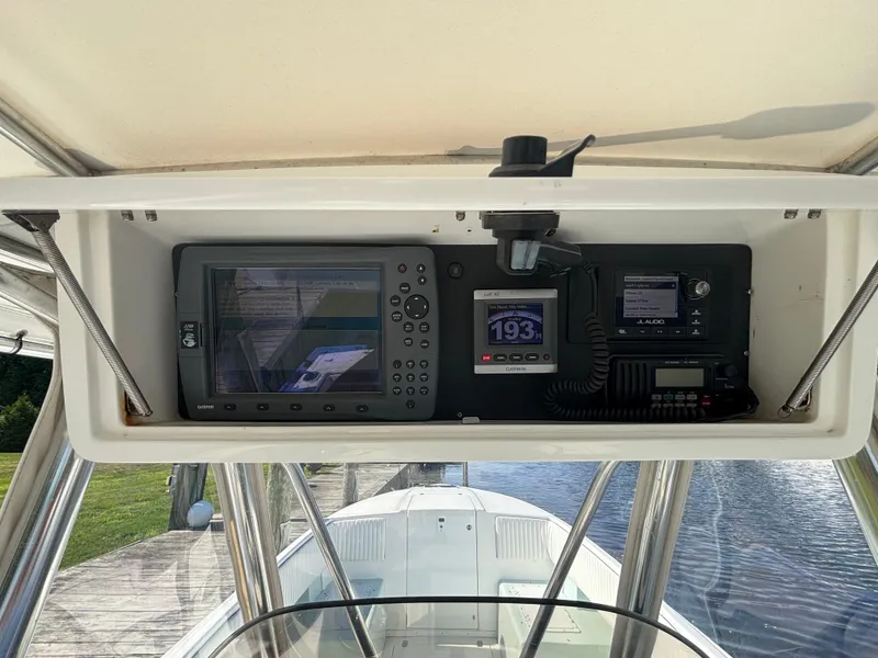 Slide: The Image of 1998 Intrepid 327 Cuddy boat dashboard with navigation and communication equipment. - 13