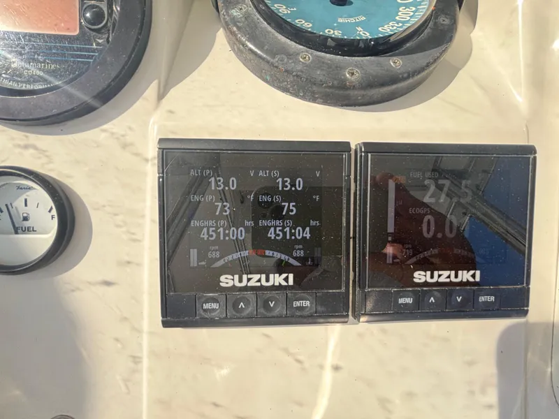 Slide: The Image of Close-up of Suzuki marine gauges on a 1998 Intrepid 327 Cuddy boat dashboard. - 14