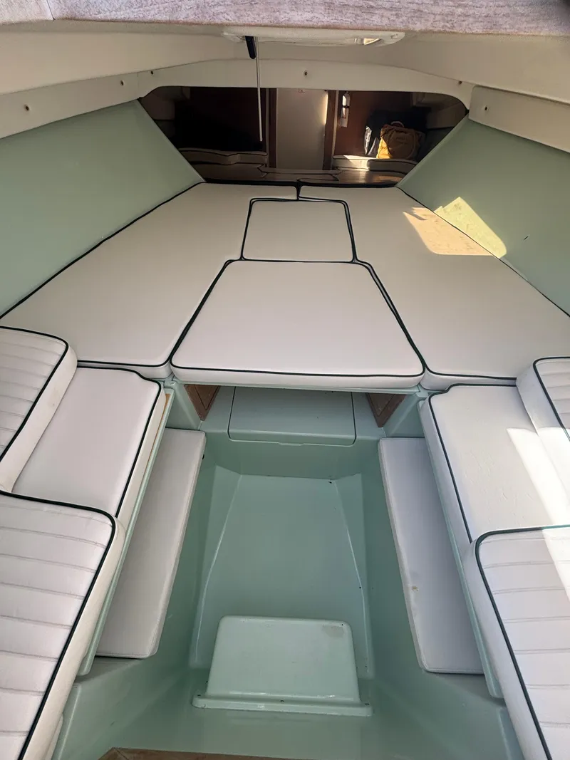Slide: The Image of Interior of a 1998 Intrepid 327 Cuddy boat with cushioned seating. - 27