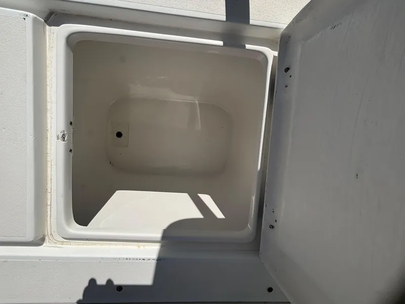 Slide: The Image of Open storage compartment on a 1998 Intrepid 327 Cuddy boat. - 29