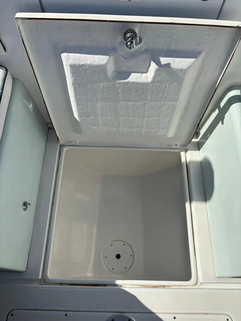Slide: The Image of Open storage compartment on a 1998 Intrepid 327 Cuddy boat. - 30