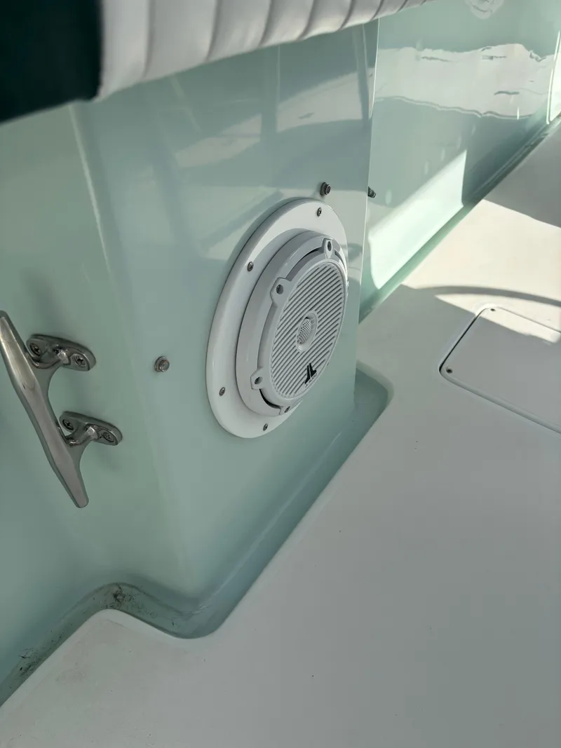 Slide: The Image of 1998 Intrepid 327 Cuddy boat interior with speaker and stainless steel cleat. - 32