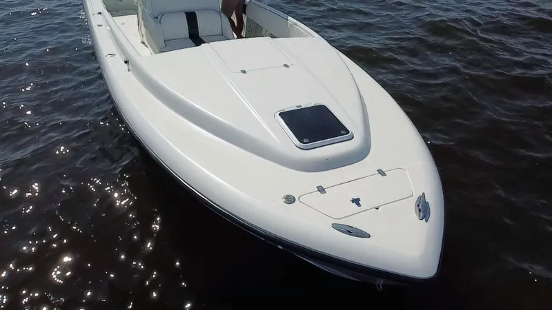 Slide: The Image of 1998 Intrepid 327 Cuddy boat on water, showcasing sleek design and white exterior. - 35