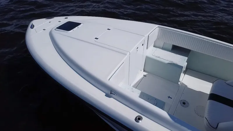 Slide: The Image of 1998 Intrepid 327 Cuddy boat, white deck, spacious seating, on calm water. - 36