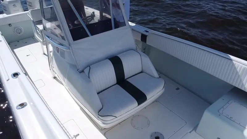 Slide: The Image of 1998 Intrepid 327 Cuddy boat interior with cushioned seating and open deck. - 38