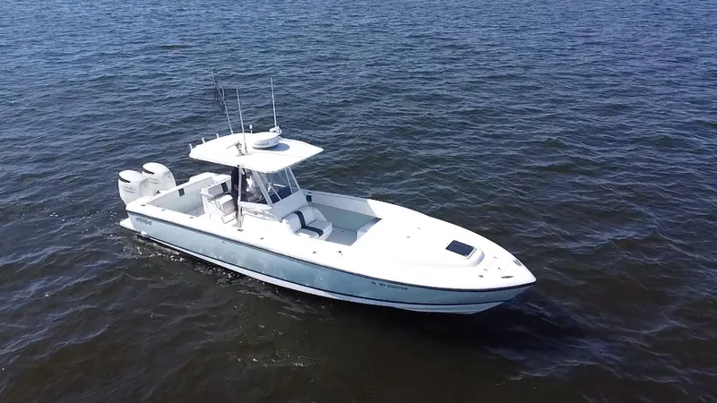 Slide: The Image of 1998 Intrepid 327 Cuddy boat cruising on open water. - 4