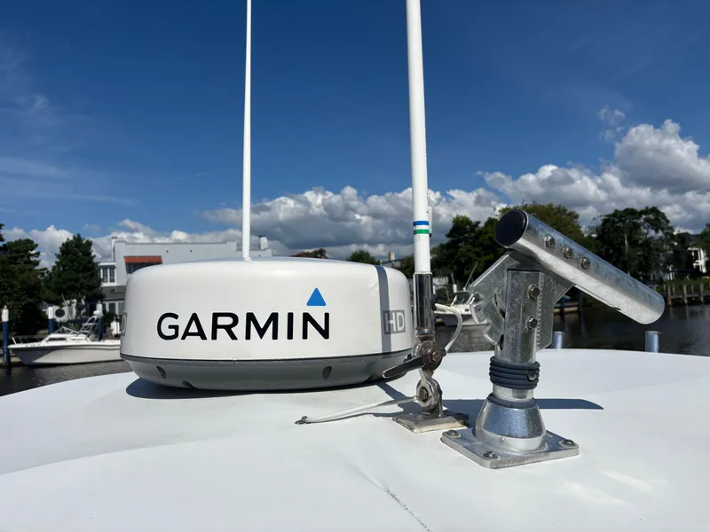 Slide: The Image of Garmin radar on 1998 Intrepid 327 Cuddy boat under clear blue sky. - 41