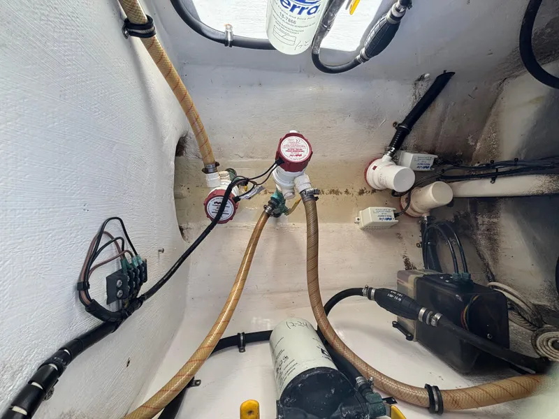Slide: The Image of Bilge area of a 1998 Intrepid 327 Cuddy boat with hoses and filters. - 42