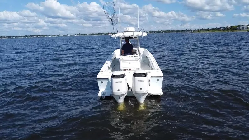 Slide: The Image of 1998 Intrepid 327 Cuddy boat with dual engines on open water. - 7