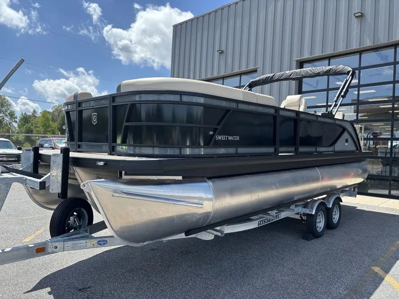 The Image of 2026 Godfrey SWEETWATER 2286 SFL pontoon boat on trailer, parked outdoors. - 0