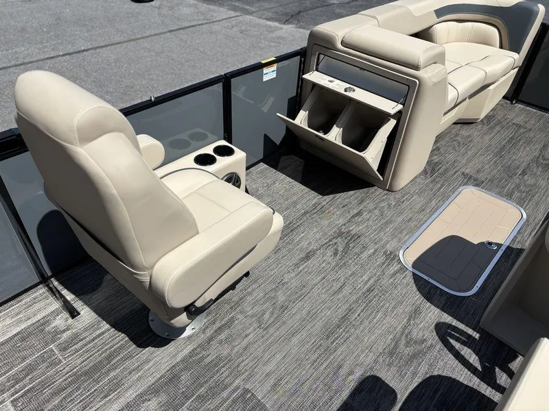 Slide: The Image of 2026 Godfrey SWEETWATER 2286 SFL boat interior with beige seating and storage compartments. - 12