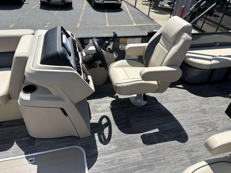 Slide: The Image of 2026 Godfrey SWEETWATER 2286 SFL boat interior with captain's chair and control panel. - 14