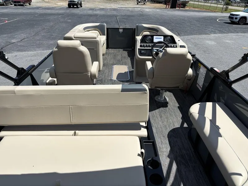 Slide: The Image of 2026 Godfrey SWEETWATER 2286 SFL pontoon boat interior with beige seating and modern dashboard. - 18