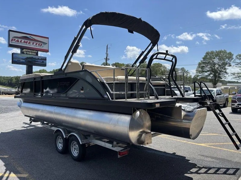 Slide: The Image of 2026 Godfrey SWEETWATER 2286 SFL pontoon boat on trailer at dealership. - 2