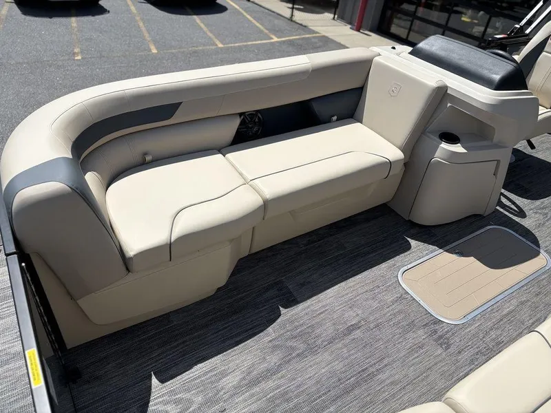 Slide: The Image of 2026 Godfrey SWEETWATER 2286 SFL boat interior with beige seating and gray flooring. - 5