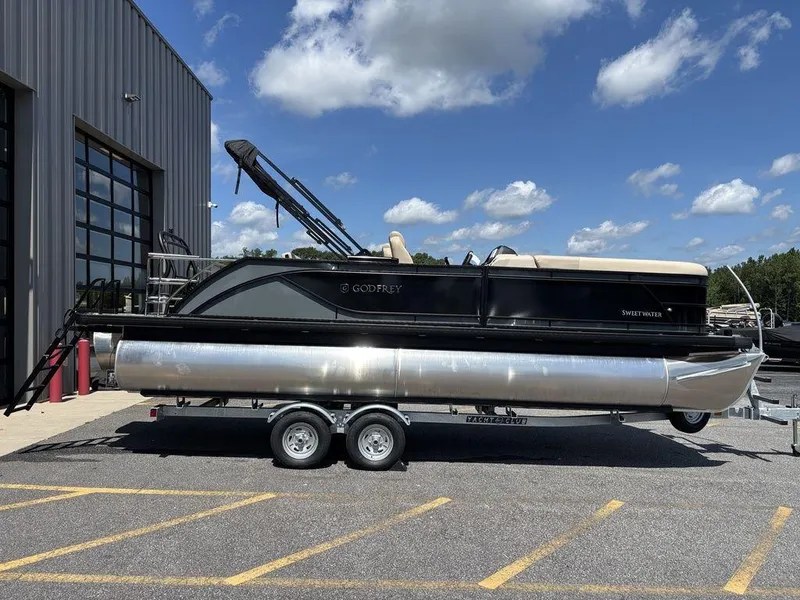 Slide: The Image of 2026 Godfrey SWEETWATER 2286 SFL pontoon boat on trailer, parked outdoors. - 6