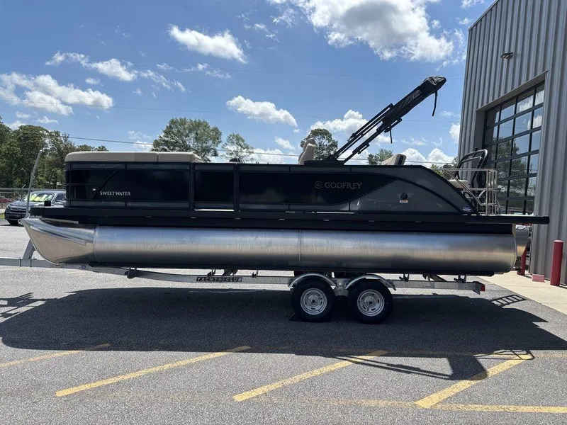 Slide: The Image of 2026 Godfrey SWEETWATER 2286 SFL pontoon boat on trailer, parked outdoors. - 7