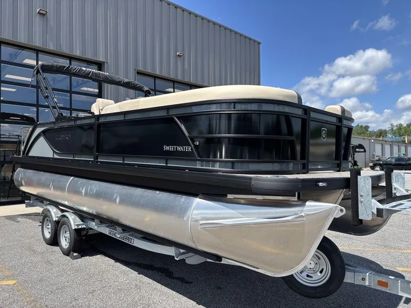 Slide: The Image of 2026 Godfrey SWEETWATER 2286 SFL pontoon boat on trailer, parked outside a building. - 8