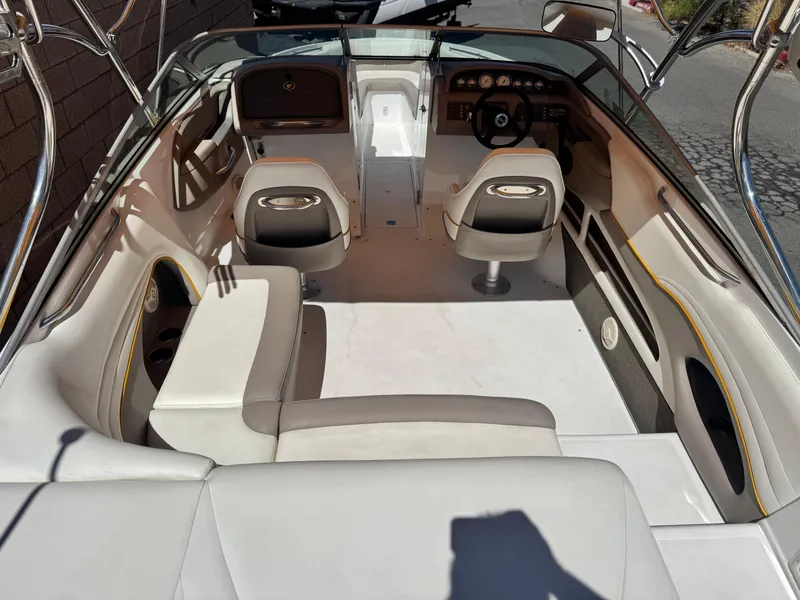 Slide: The Image of Interior of a 2006 Cobalt 246 boat, featuring seating and steering area. - 10