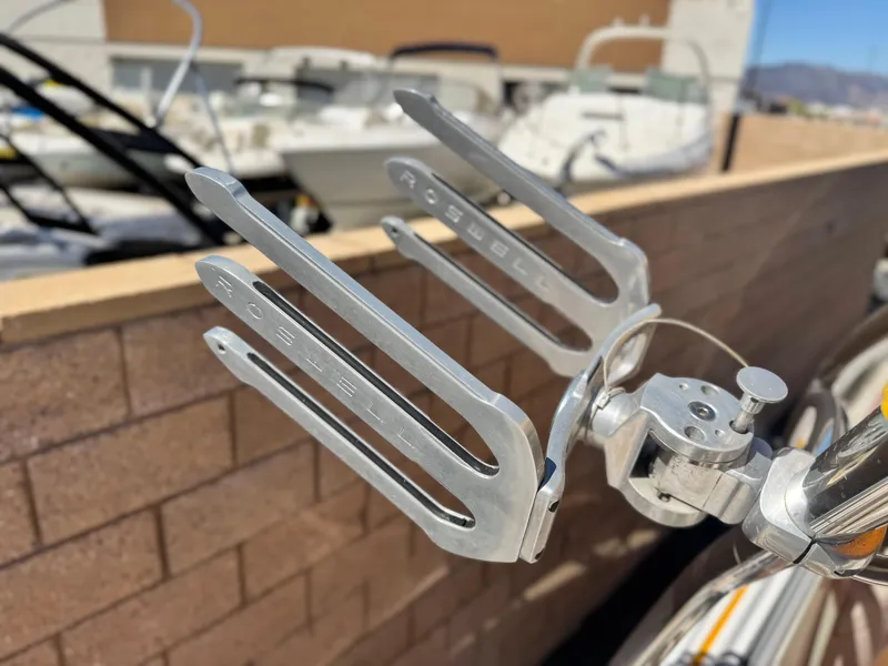 Slide: The Image of Roswell wakeboard rack on a 2006 Cobalt 246 boat, with blurred background. - 12