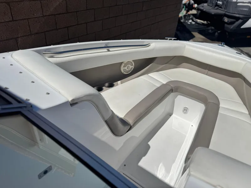 Slide: The Image of 2006 Cobalt 246 boat interior with white and gray seating, cup holders, and speaker. - 15