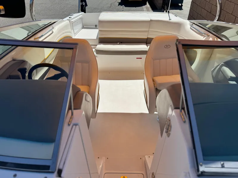 Slide: The Image of Interior of a 2006 Cobalt 246 boat with beige seating and dual consoles. - 17