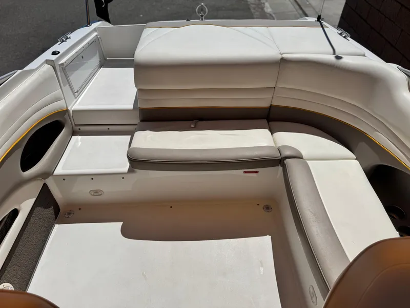 Slide: The Image of Interior seating of a 2006 Cobalt 246 boat, featuring white and beige upholstery. - 18