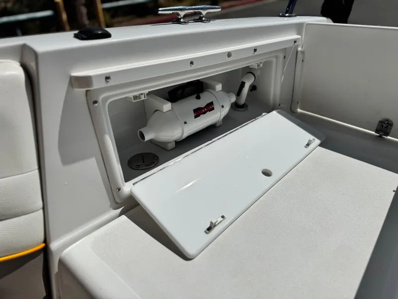 Slide: The Image of Open storage compartment on a 2006 Cobalt 246 boat, showing internal components. - 23