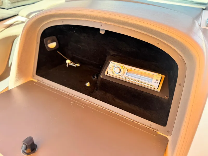 Slide: The Image of 2006 Cobalt 246 glove compartment with stereo system and small storage space. - 25