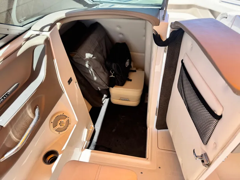 Slide: The Image of Interior cabin of a 2006 Cobalt 246 boat with storage and seating. - 26