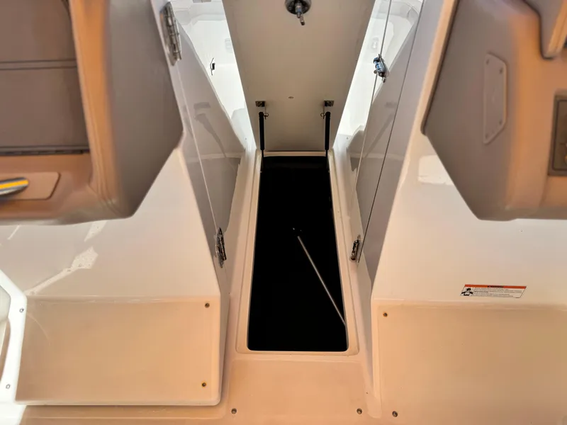 Slide: The Image of Open storage compartment on a 2006 Cobalt 246 boat, showcasing interior space. - 27