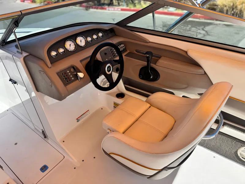 Slide: The Image of Interior of a 2006 Cobalt 246 boat showing steering wheel and dashboard controls. - 28