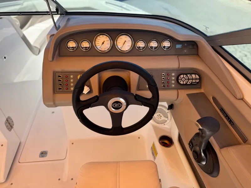 Slide: The Image of 2006 Cobalt 246 boat dashboard with steering wheel and control panel. - 29