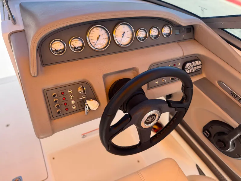 Slide: The Image of Dashboard of a 2006 Cobalt 246 boat with steering wheel and gauges. - 30