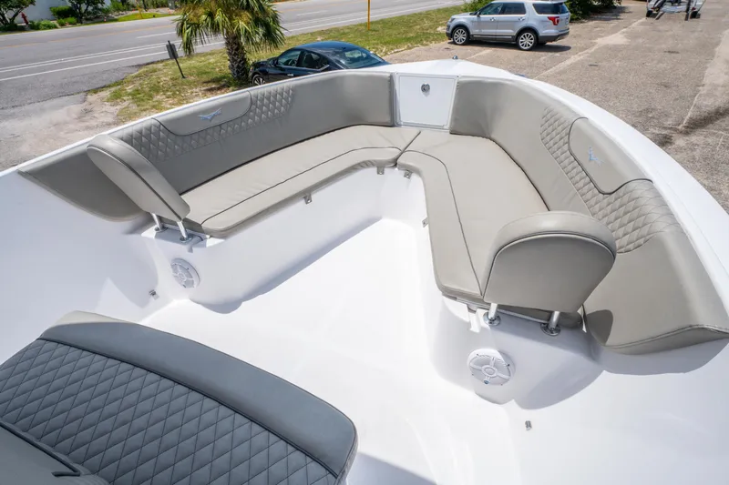 Slide: The Image of 2024 Savannah 2900 Offshore boat with spacious, cushioned seating area and modern design. - 12