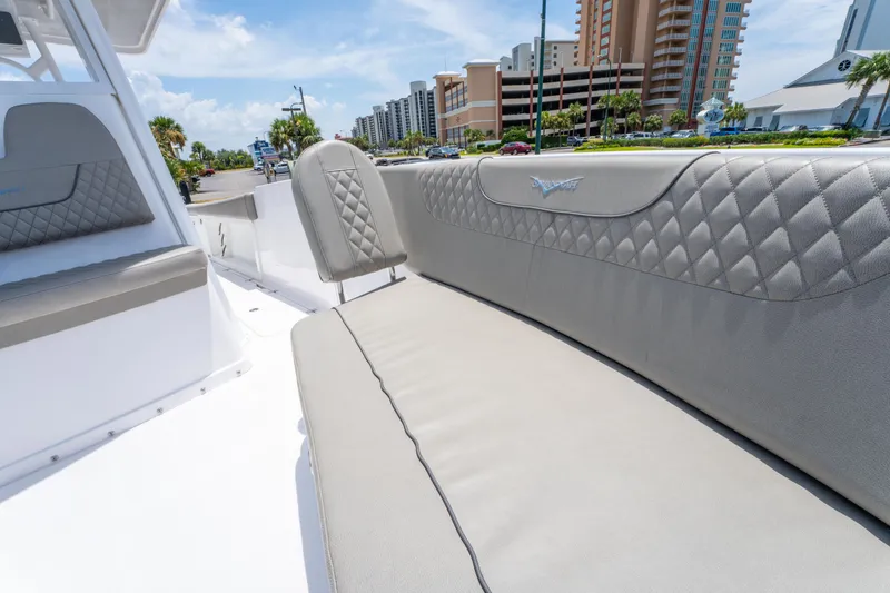 Slide: The Image of 2024 Savannah 2900 Offshore boat interior with luxurious seating and urban backdrop. - 14